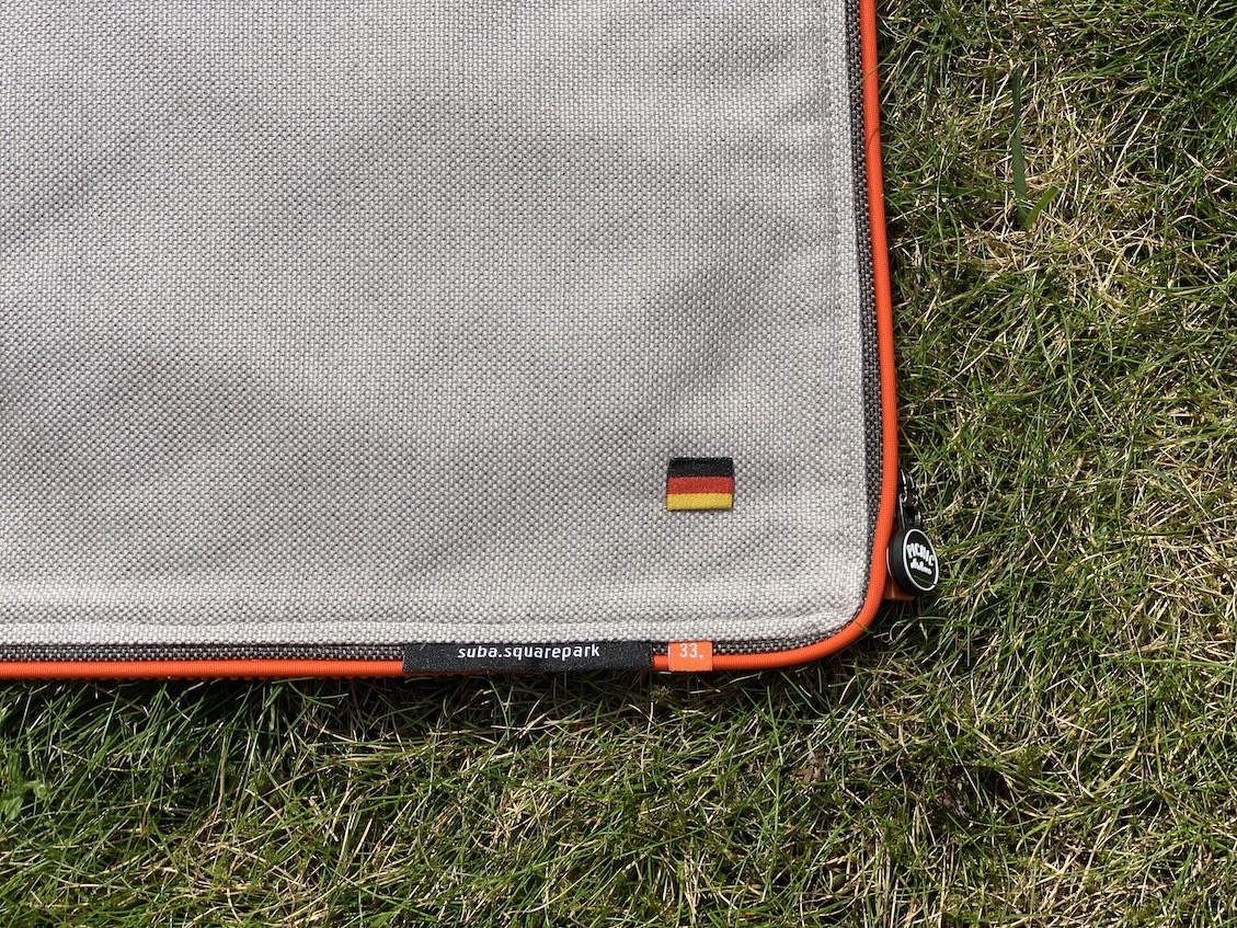 Detail close-up of the lower right corner of the suba.squarepark.33.silvergrey, featuring the German flag label.