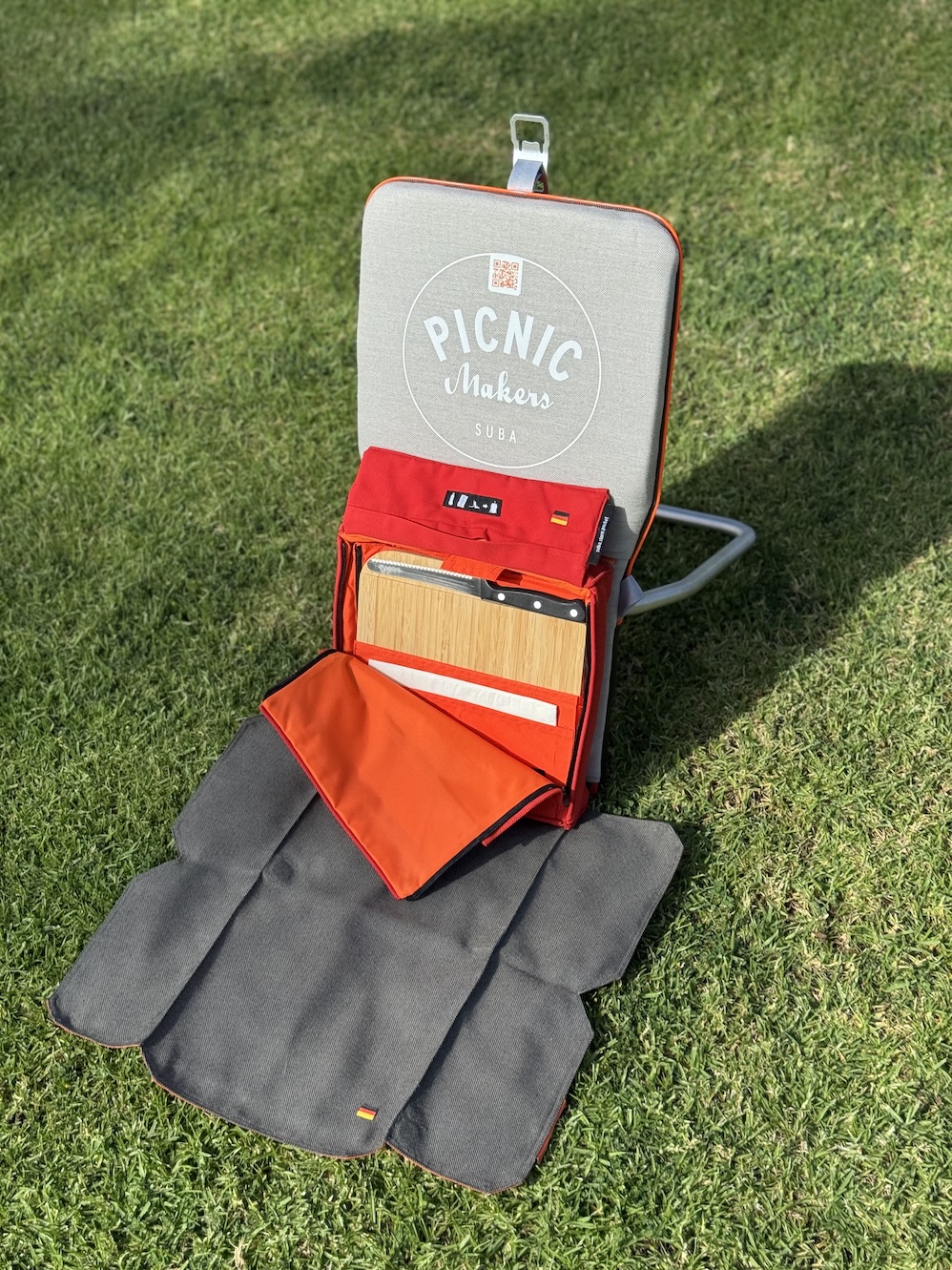 suba.backrest.silvergrey-with-attached-suba.store.pocket-via-suba.zipsystem-on-grass-sunlit-outdoor-setting